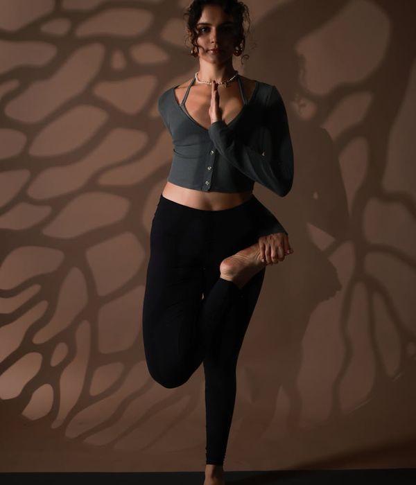 Woman in a calm yoga pose, embodying harmony and balance.